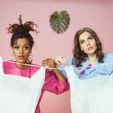 women holding plastic bags on the clothesline