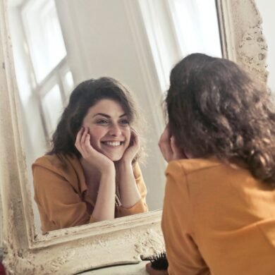 photo of woman looking at the mirror