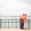 stylish elderly couple kissing on embankment