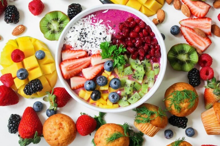 assorted sliced fruits in white ceramic bowl